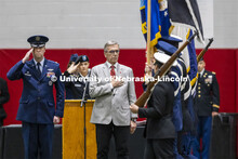 Air Force Lieutenant Colonel C J Zaworski and UNL Chancellor Ronnie Green salute the colors as they 