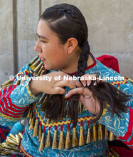 Alicia Scholfield braids her hair before the start of the UNITE powwow. Scholfield's family traveled