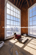 Erin Colonna, graphic designer with the University Libraries, documents signatures on the walls insi