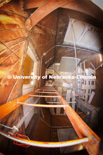 Erin Colonna, graphic designer with the University Libraries, climbs down the ladder from the Love L