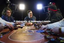 Alec Rome, rakes in the pot as Collin Streu, left, Lance Ammons, right, fold their hands. Rome, a se