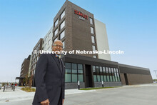Dipra Jha stands before the completed Scarlet Hotel. As a HTRM professor, he was instrumental at get