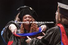 Dahlia Lloyd is hooded during the ceremony. Graduate commencement in Pinnacle Bank Arena. May 13, 20