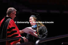 Chancellor Ronnie Green hands out diplomas to grads. Graduate commencement in Pinnacle Bank Arena. M