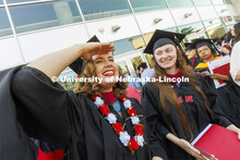 Anna Kuhlman looks for her family outside Pinnacle Bank Arena following commencement. Graduate comme