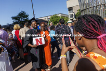 Darwin Archie-Pettis poses for family photos with his masters degree outside Pinnacle Bank Arena fol