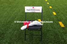 A chair with flowers and a program was in the corner of Memorial Stadium in honor of Regan Lauber wh