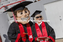 Carol (Dahl Leacox) Livingston takes a photo with Herbie Husker. Livingston finally received her dip