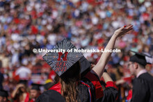 Ashton Koch’s bedazzled mortarboard sparkles in the morning sun. UNL undergraduate commencement in