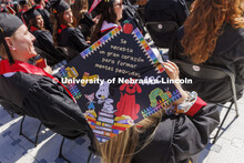 Decorated mortarboards at UNL undergraduate commencement in Memorial Stadium. May 14, 2022. 