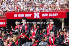 Graduates who have served in the military stand and are honored during the UNL undergraduate commenc