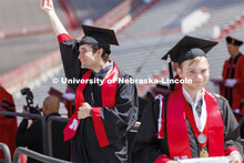 Anthony Wynegar shows off his college of Engineering diploma to friends and family. UNL undergraduat