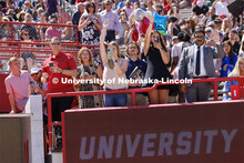Friends and family crowd the rail to photograph their graduates. UNL undergraduate commencement in M