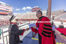 Carol (Dahl Leacox) Livingston receives her diploma from Chancellor Ronnie Green. Livingston finally