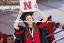 Skylar Hanson waves to her family as she returns to her seat with her diploma. UNL undergraduate com