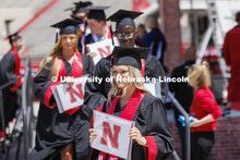 Lauryn Riepma shows off her diploma. UNL undergraduate commencement in Memorial Stadium. May 14, 202