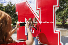 Grace and Emma Alder, twin sisters from Atkinson, NE, pose for NSE Leader Hannah-Kate Kinney in fron