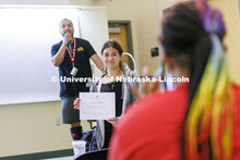 Jocelyn Cabellos, a frehsman at Omaha South, holds up her certificate for a photo as David Orozco-Ga
