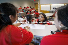 Ana Cortez Martir, junior from Omaha South High school, works with her team as they develop a busine
