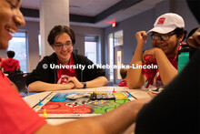 Attendees smile as they play a game of Sorry! at the Nebraska College Preparatory Academy’s Scienc