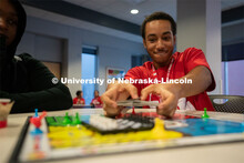 An attendee shuffles cards during a game of Sorry! at the Nebraska College Preparatory Academy’s S
