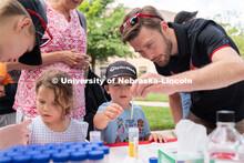 Discovery Day attendees create balls using liquid samples. The East Campus Discovery Days and Farmer