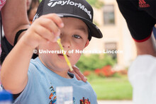 Discovery Day attendees create balls using liquid samples. The East Campus Discovery Days and Farmer