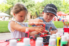 Two Discovery Day attendees pick different paint colors to paint rocks. The East Campus Discovery Da