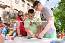 Discovery Day attendees work together to build a lego car. The East Campus Discovery Days and Farmer