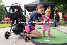 Discovery Day attendees try to putt the ball into the hole. The East Campus Discovery Days and Farme