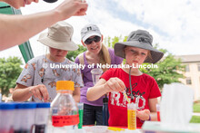 Discovery Day attendees create balls using liquid samples. The East Campus Discovery Days and Farmer