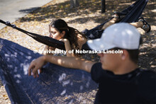 Karla Zavala and Matthew Klein, both from Fremont, hang out in the hammocks outside the Nebraska Uni