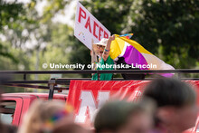 University of Nebraska representatives wave to the crowd during the Star City Pride parade. June 18,