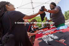 Jerri Harner (right), executive specialist to the vice chancellor for diversity and inclusion, hands