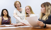Katrina Jagodinsky, Associate Professor of History (standing), works with REU students engaged with 