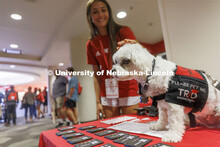 Neo the Trio support dog is gets a scratch from NSE student Katie Torres of Plattsmouth. Neo welcome