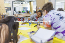 Alana Denney laughs while looking at images for her design with academy mentor Shiloh King. 2022 MAT