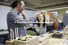 Lloyd “Bud” Shenefelt, Assistant Professor of Architecture, critiques a hanging design by first 