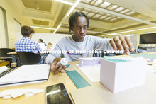 Jaylen Epting, a second-year student from Omaha, works on his design in Lloyd “Bud” Shenefelt’