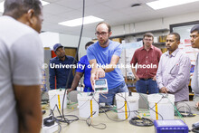 Derek Heeren and his class work with measuring water content in soil samples in his Irrigation Labor