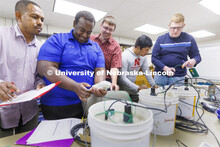Derek Heeren and his class work with measuring water content in soil samples in his Irrigation Labor