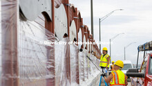 Reni Buehler rolls while Dirk Edwards edges the wave-patterned artwork on the overpass. Building Sys
