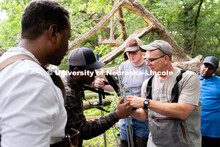 Research Engineer Alan Boldt (right) helps students assemble tools to measure the water flow rates o