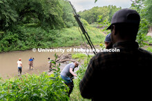 Students take turns climbing down to Salt Creek using a rope at Wilderness Park. Irrigation Laborato