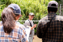 Research Engineer Alan Boldt (center) instructs students on how to measure and record the water flow