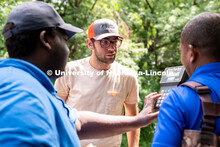Eric Wilkening (center) watches as data is being read from a FlowTracker machine during the Irrigati
