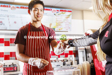 Randy Nguyen serves up a cone of Clover 4-H Mint. Ice cream is scooped up at the Dairy Store on East
