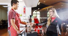 Randy Nguyen (left) serves up a towering five-scoop ice cream cone to Lauren Ahlers, a first-year ve