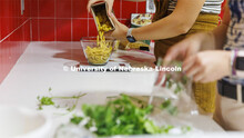 Brenna Mazour, a senior in psychology and dietetics, measures pasta as Meredith Brandt, junior in nu