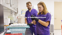 Dulcie Archuleta, a student at Nebraska Wesleyan, holds a sample as Tony Juritsch, her graduate stud